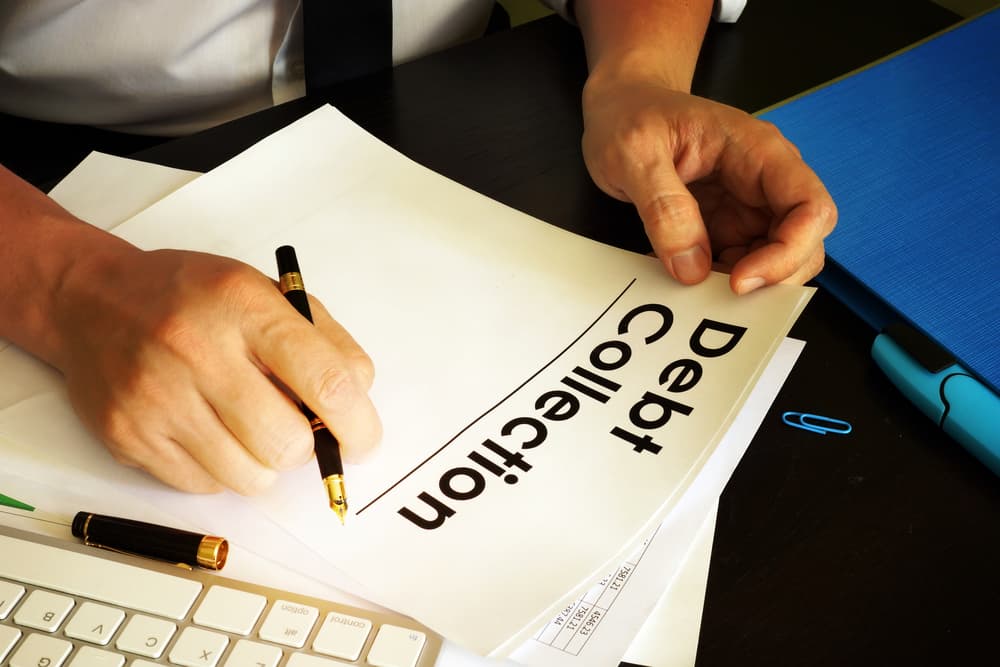 Manager holding documents related to debt collection.